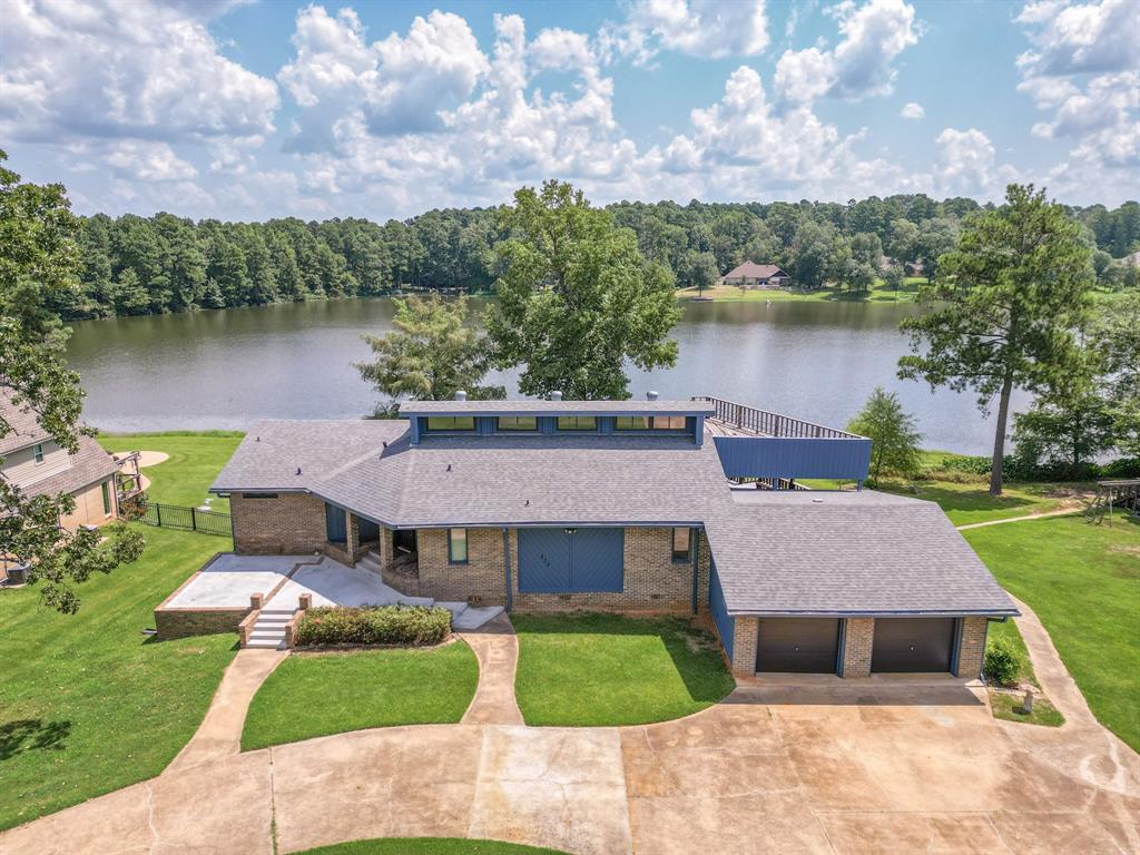 an aerial view of a house with a yard and a fountain