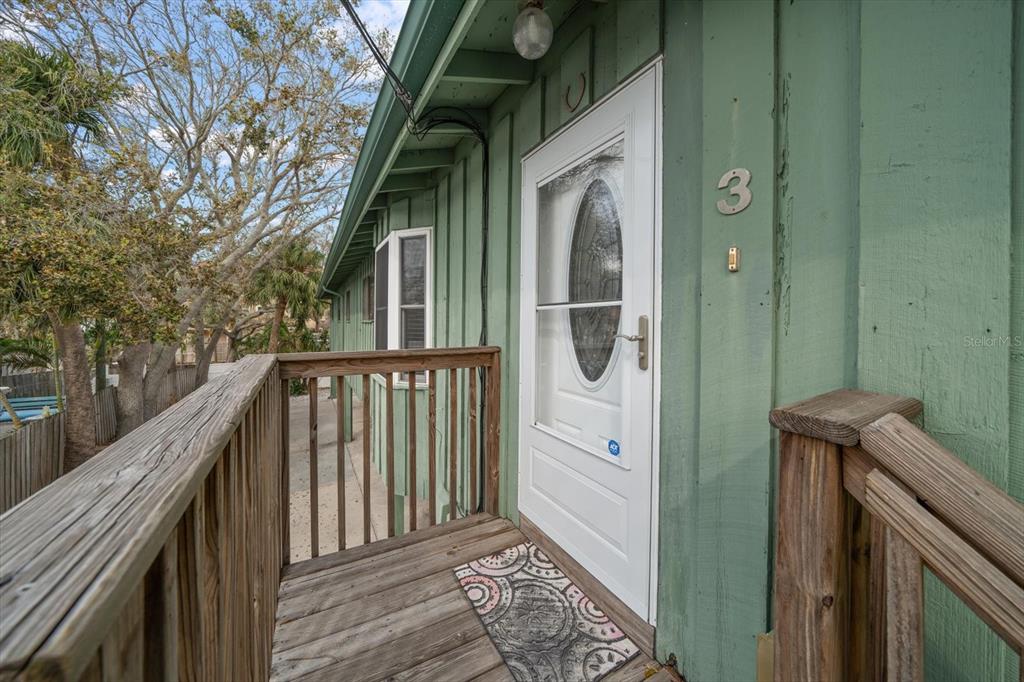 a view of balcony and wooden fence