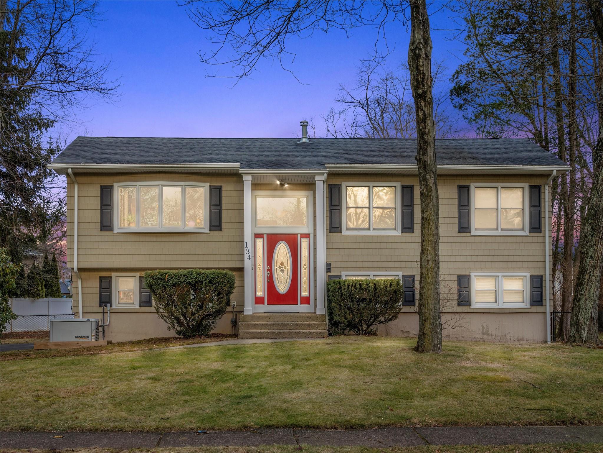 Split foyer home featuring a yard