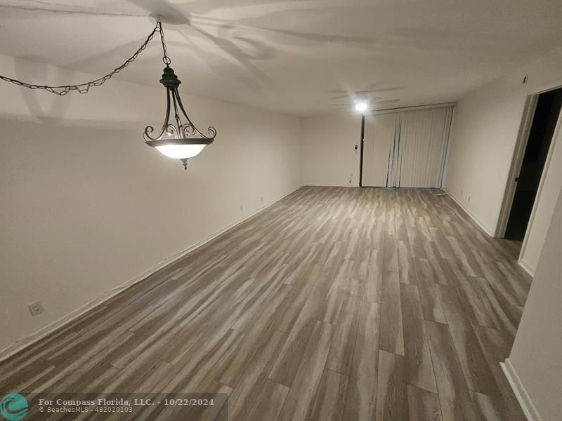 a view of a room with wooden floor and staircase