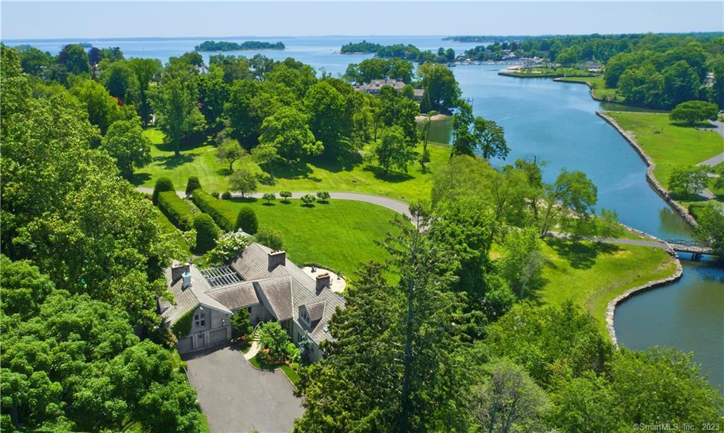 an aerial view of a house with a yard and lake view