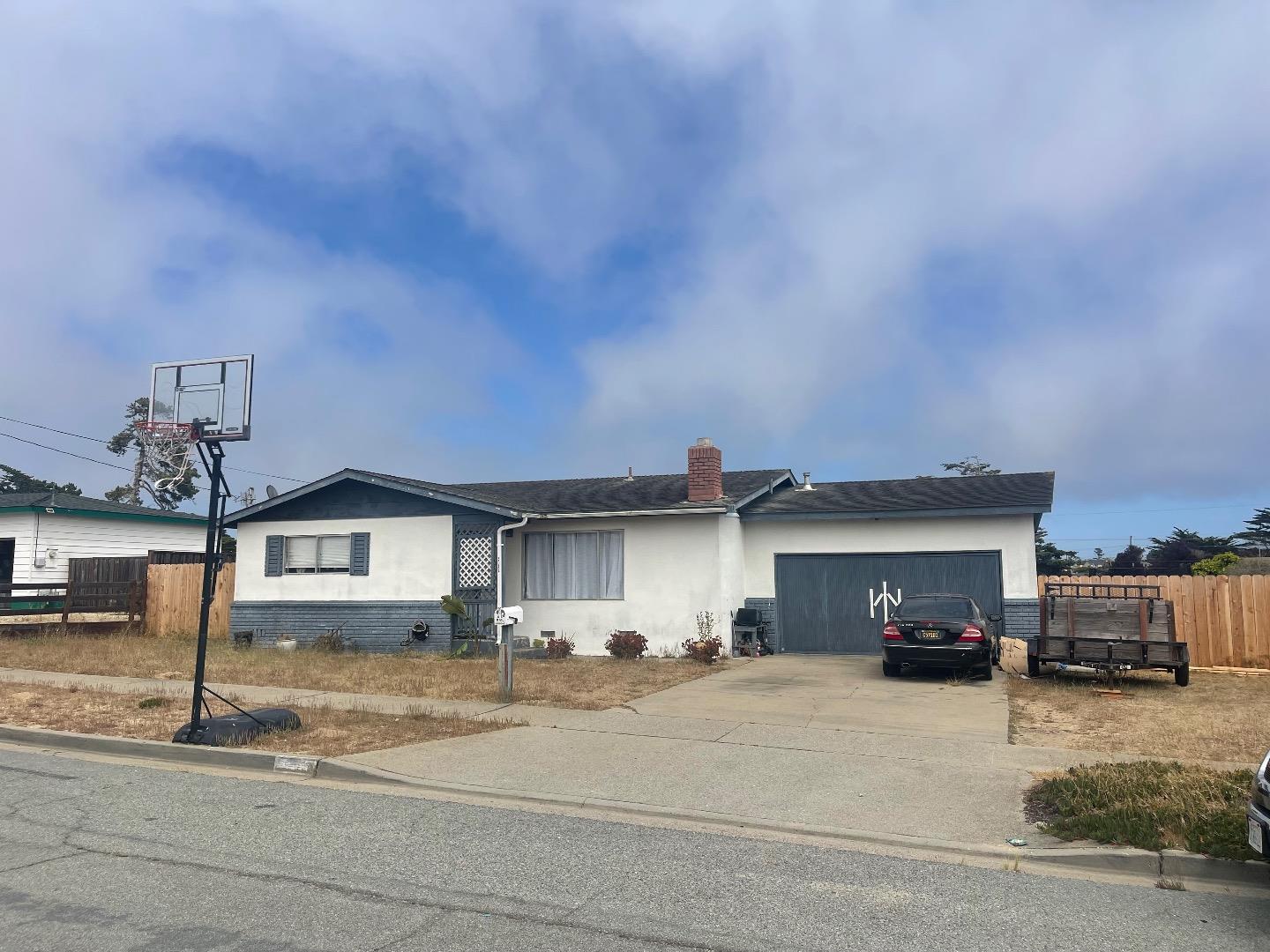 a view of a house with a entertaining space and a car parked front of it