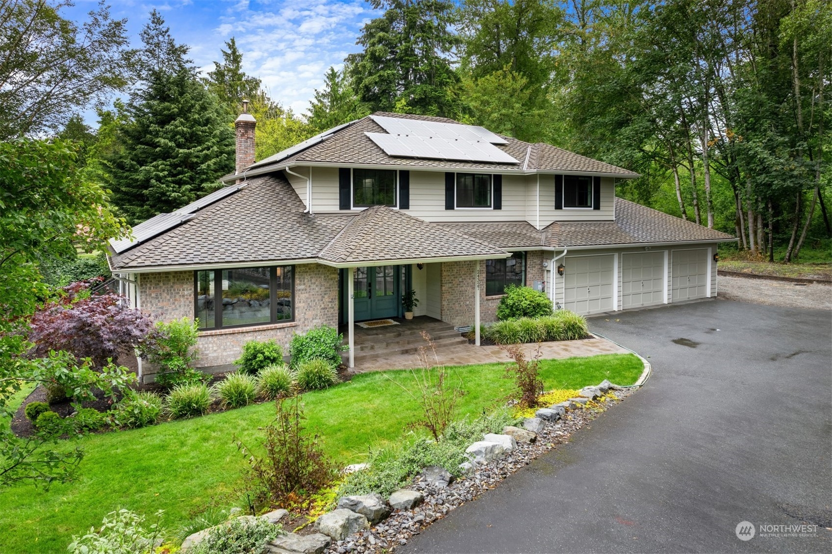 a front view of a house with a yard and porch