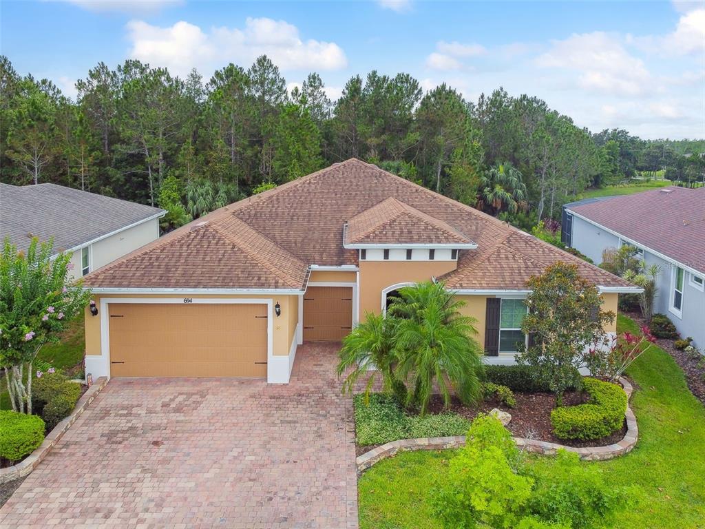 a aerial view of a house next to a yard