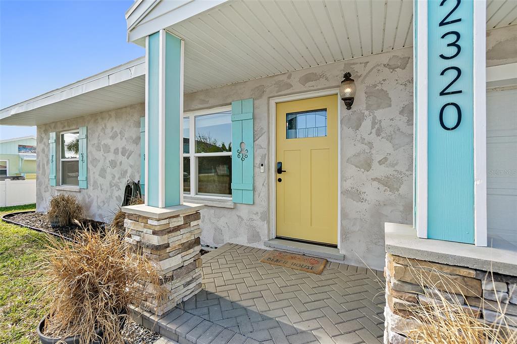 a front view of a house with outdoor seating