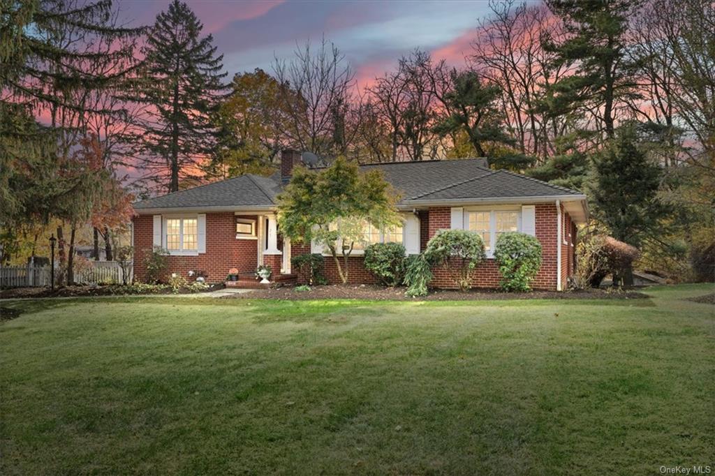 Single story home featuring a lawn