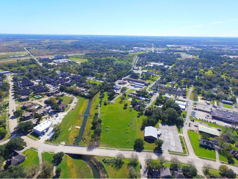 an aerial view of residential houses with outdoor space and street view