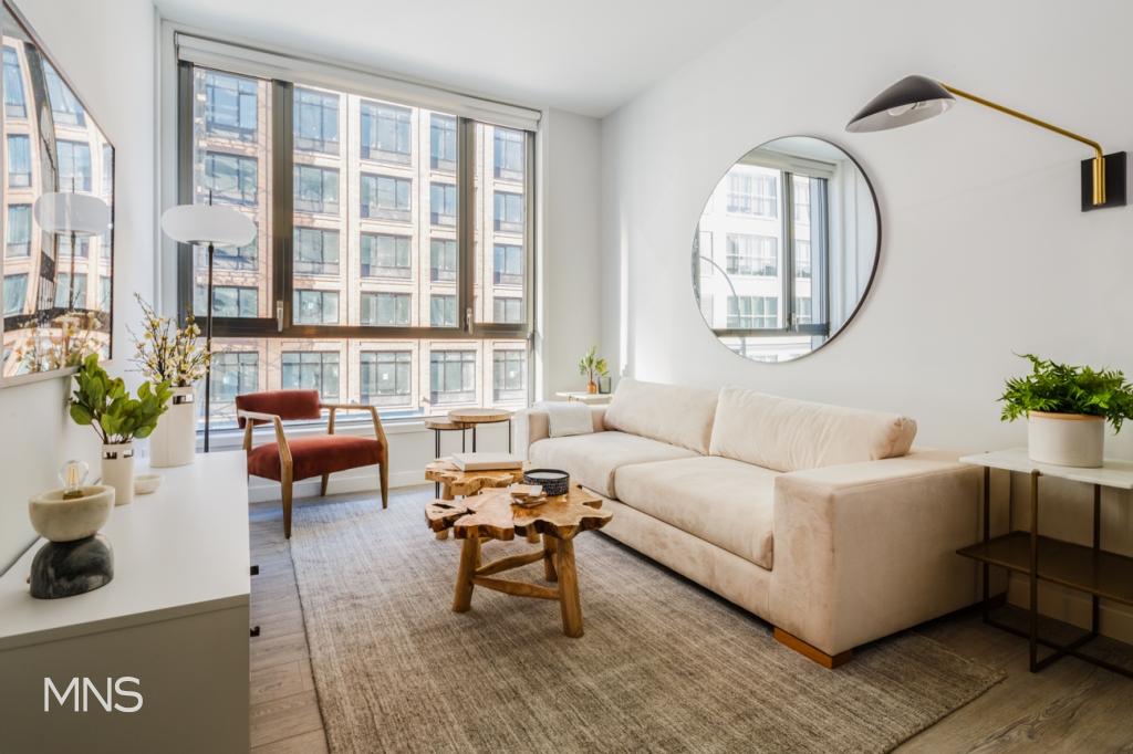 a living room with furniture and a large window