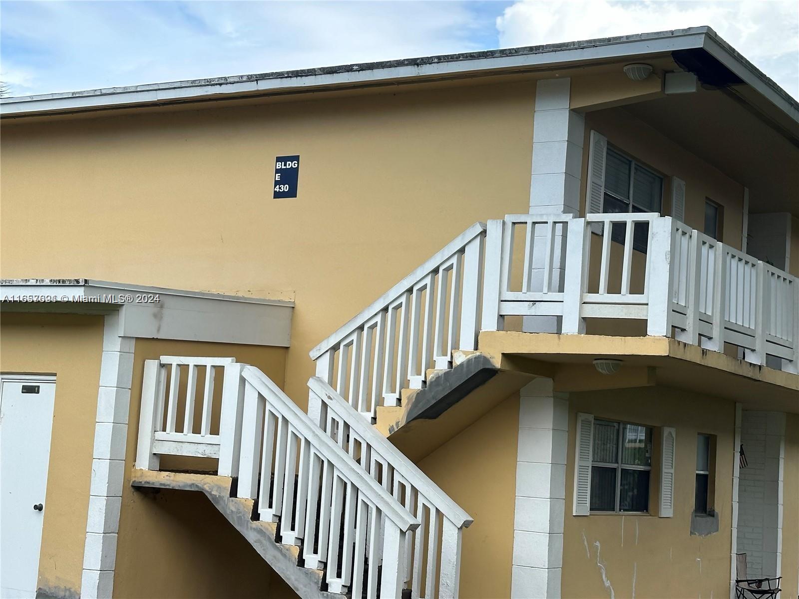 a view of a house with wooden deck