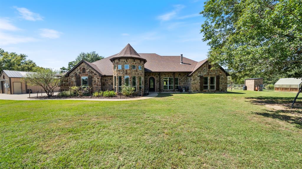 a front view of a house with yard and green space