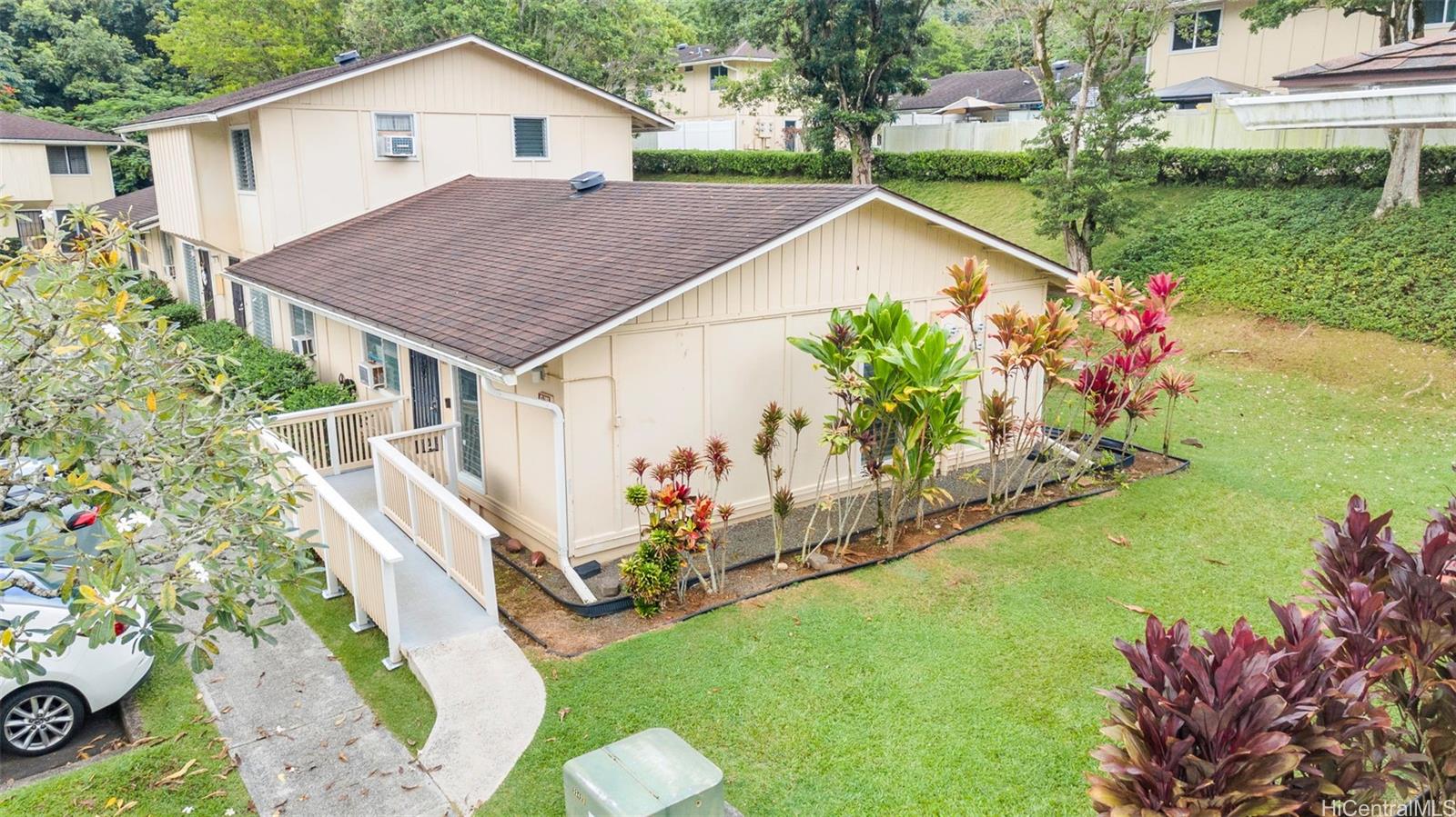 a view of a house with a yard and garden