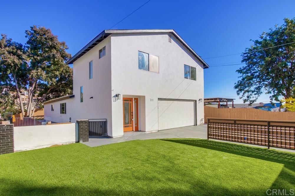 a front view of a house with a garden