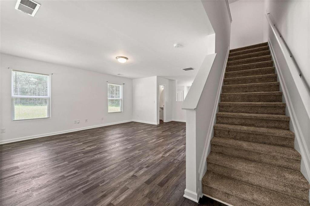 a view of an entryway with wooden floor