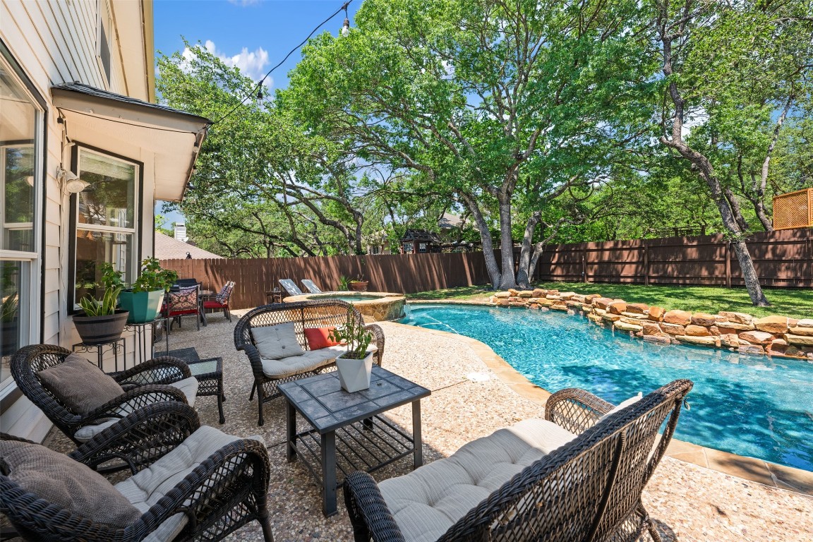 a view of backyard with seating area and green space