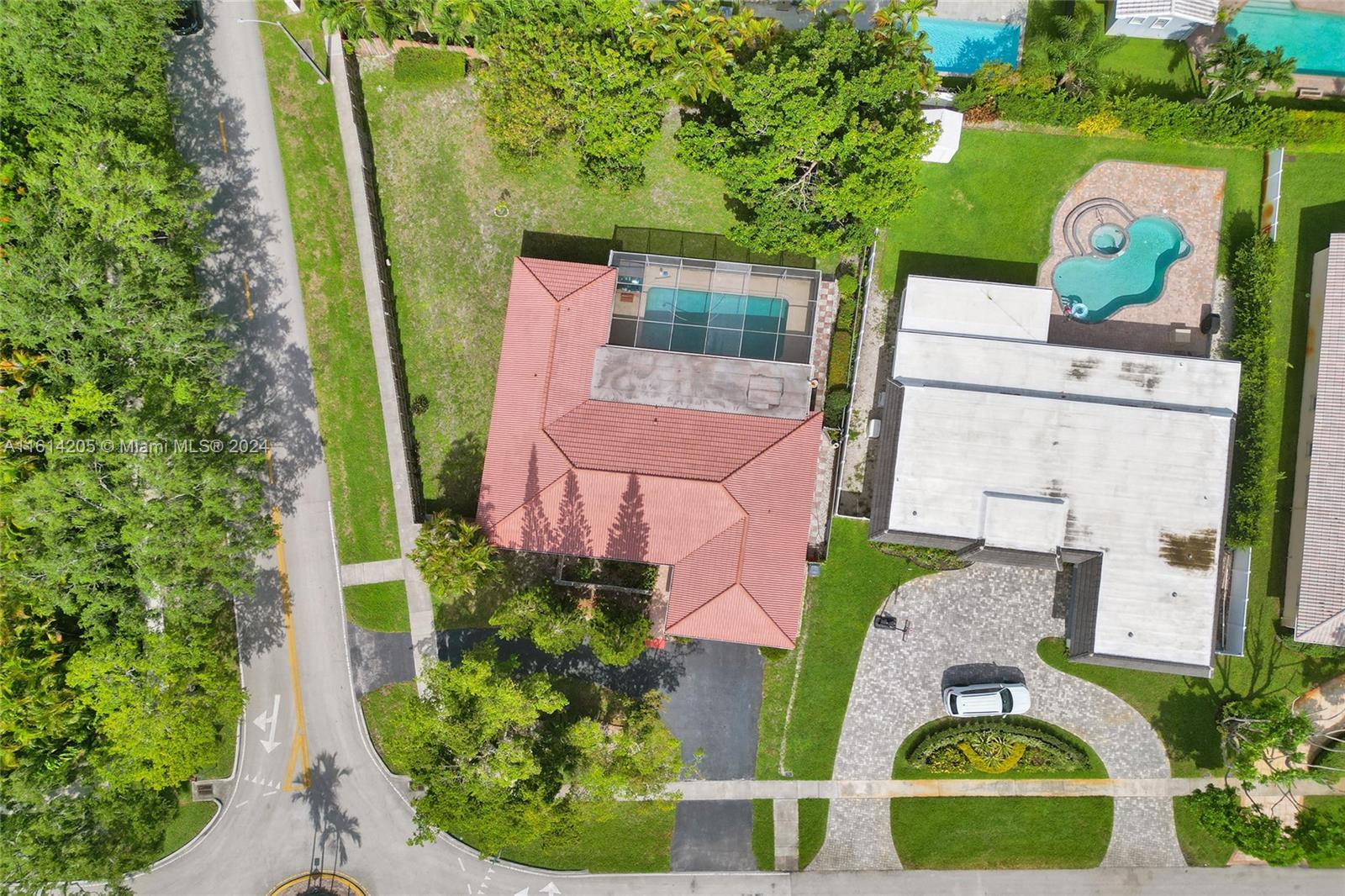 an aerial view of a house with swimming pool and garden