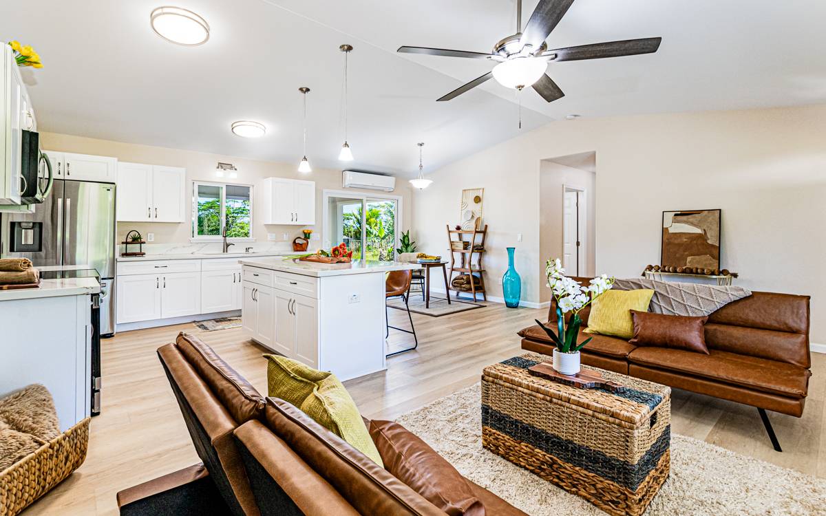 a living room with furniture and a dining table