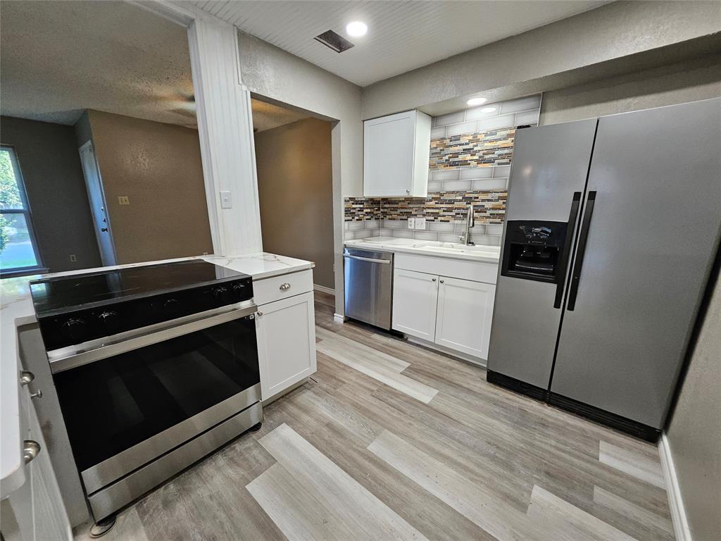 a kitchen with a stove microwave and refrigerator