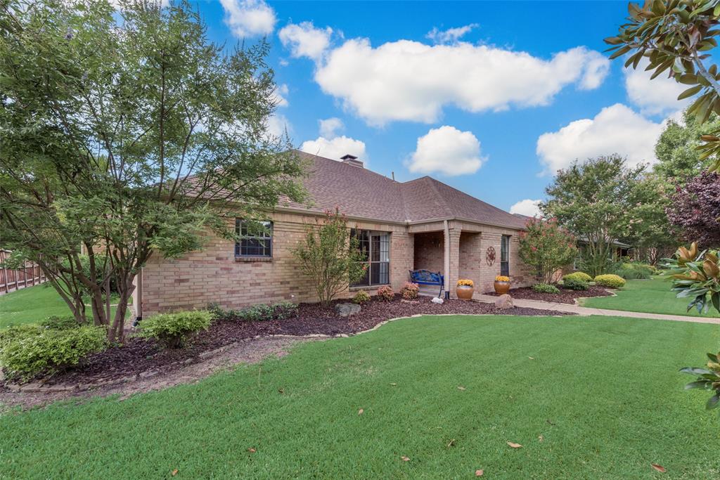 a front view of a house with patio and garden