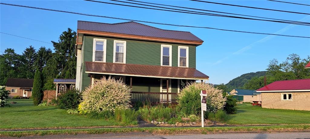 a front view of a house with a garden