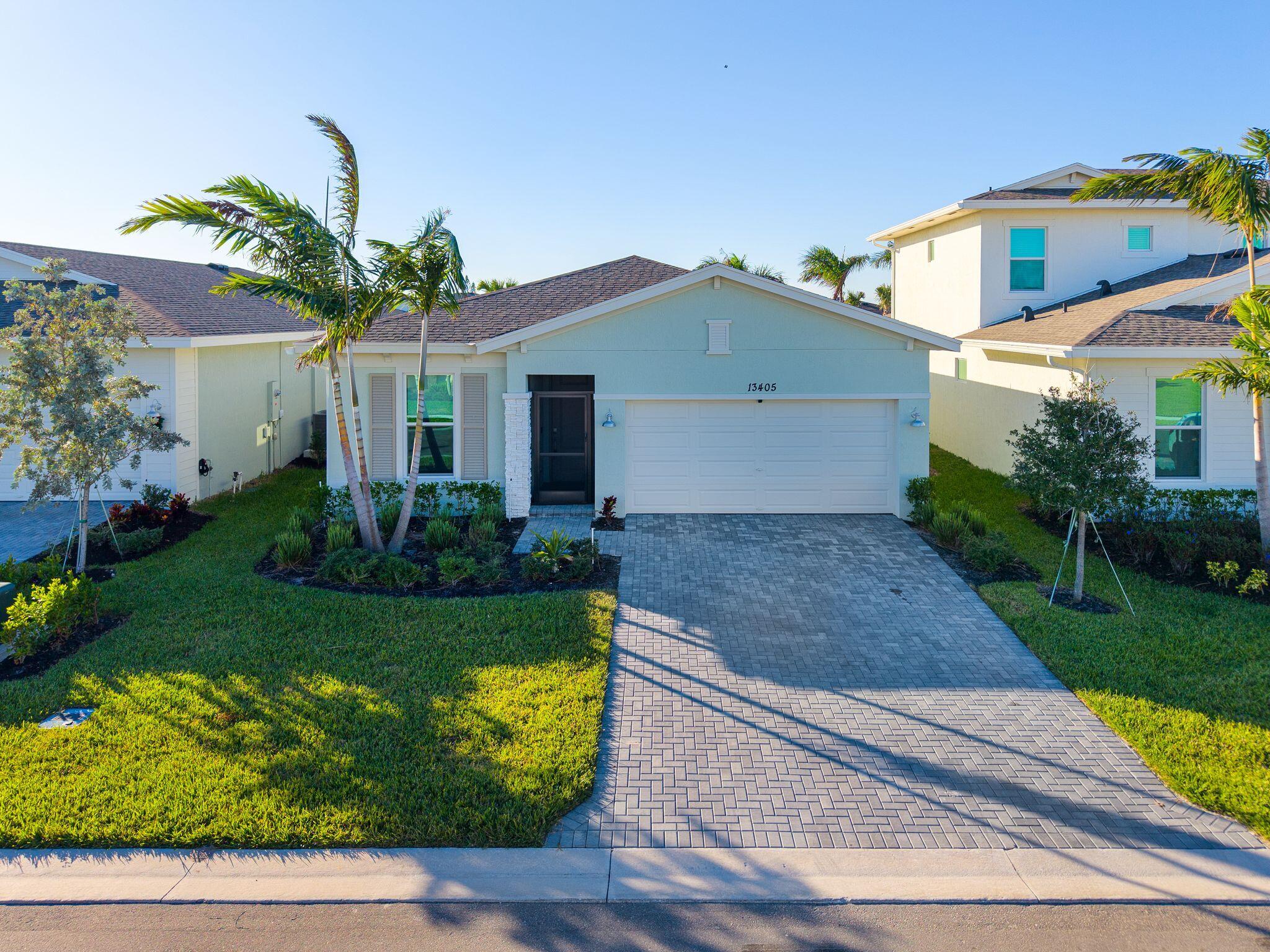 a front view of house with yard and green space