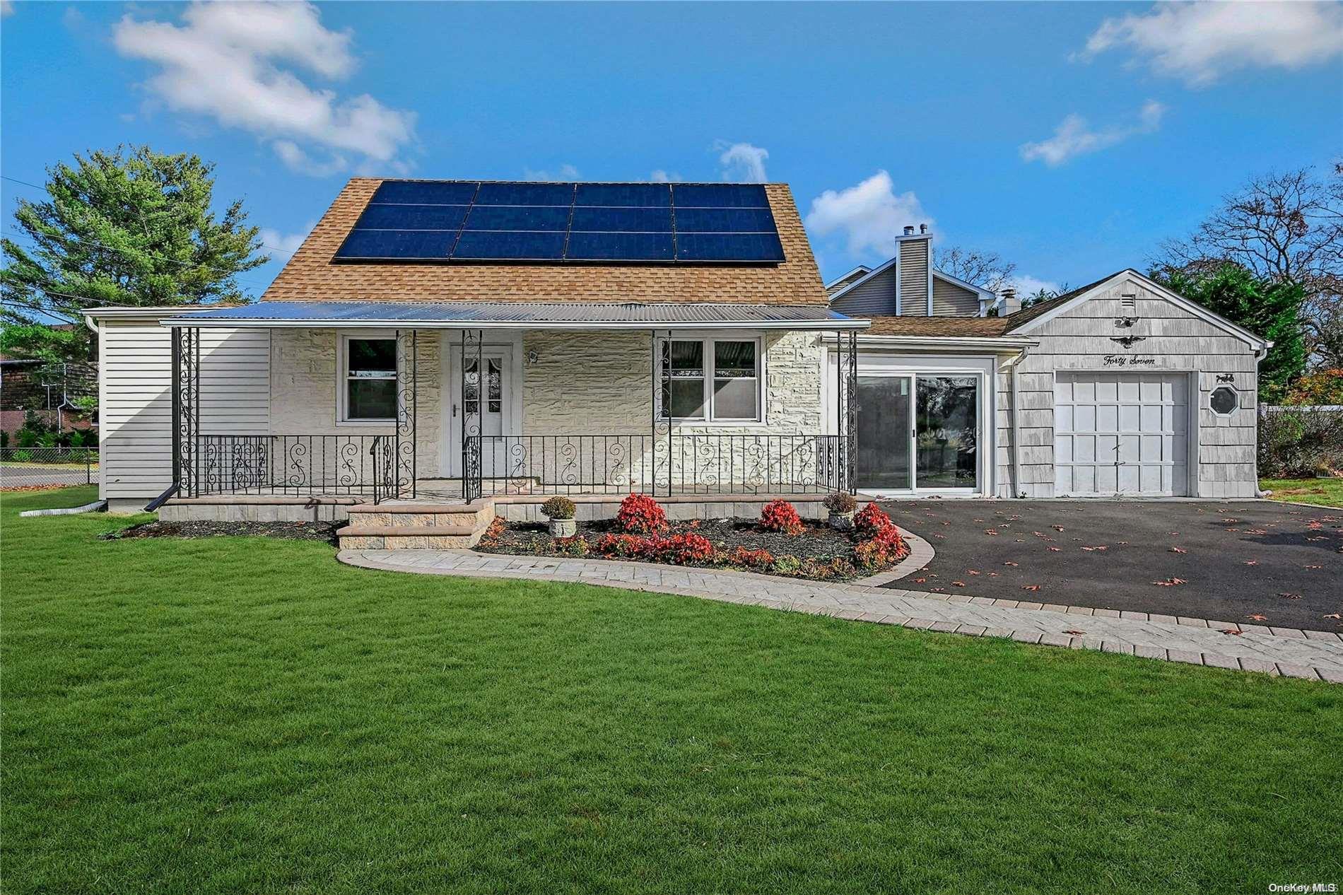 a front view of house with yard and outdoor seating