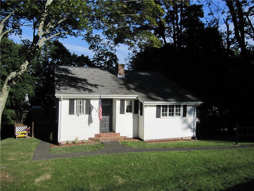 a front view of a house with a garden and yard