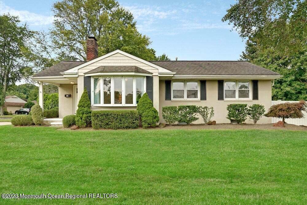 a front view of a house with a garden