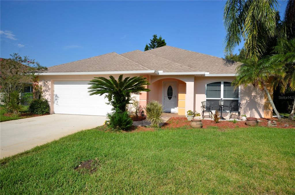 a front view of a house with patio and yard