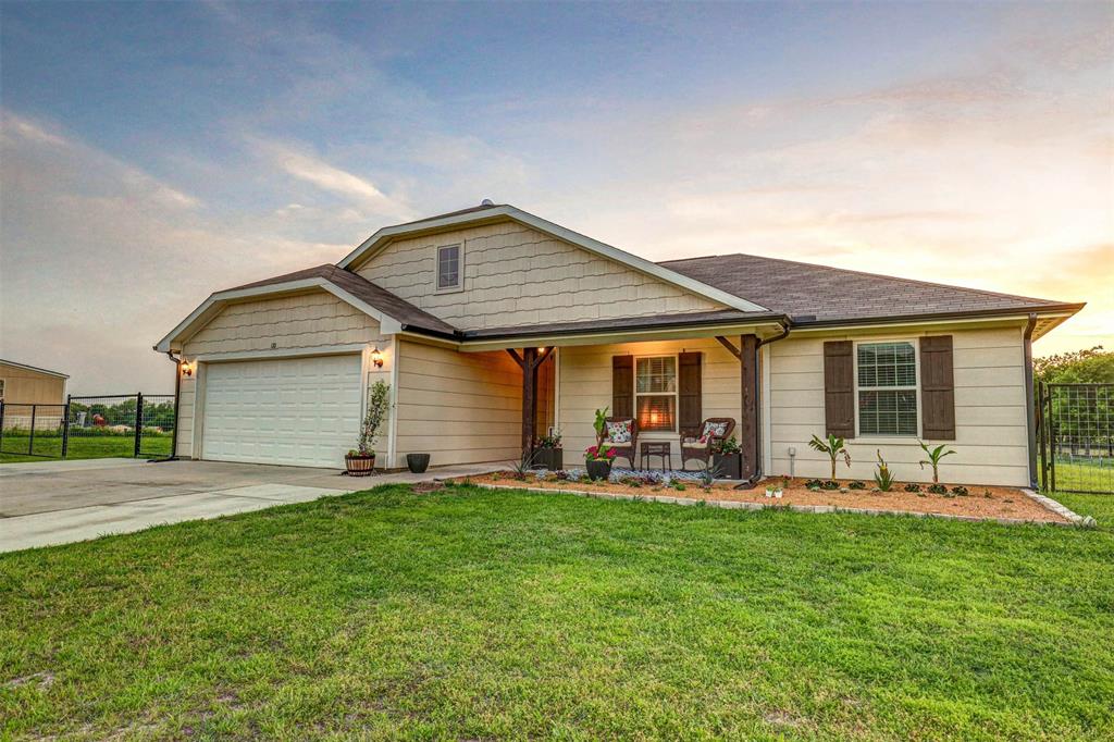 a front view of house with yard and outdoor seating