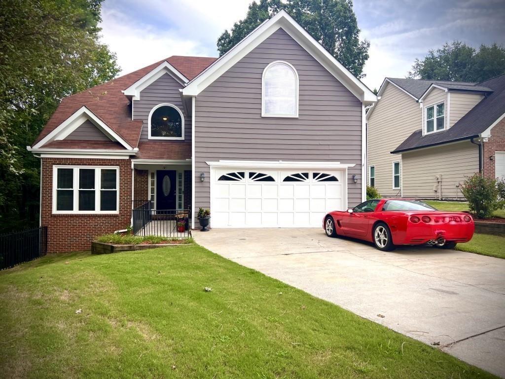 a front view of a house with a yard and garage