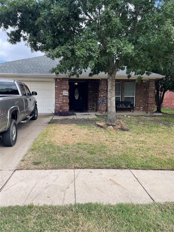 a view of a car parked in front of a house