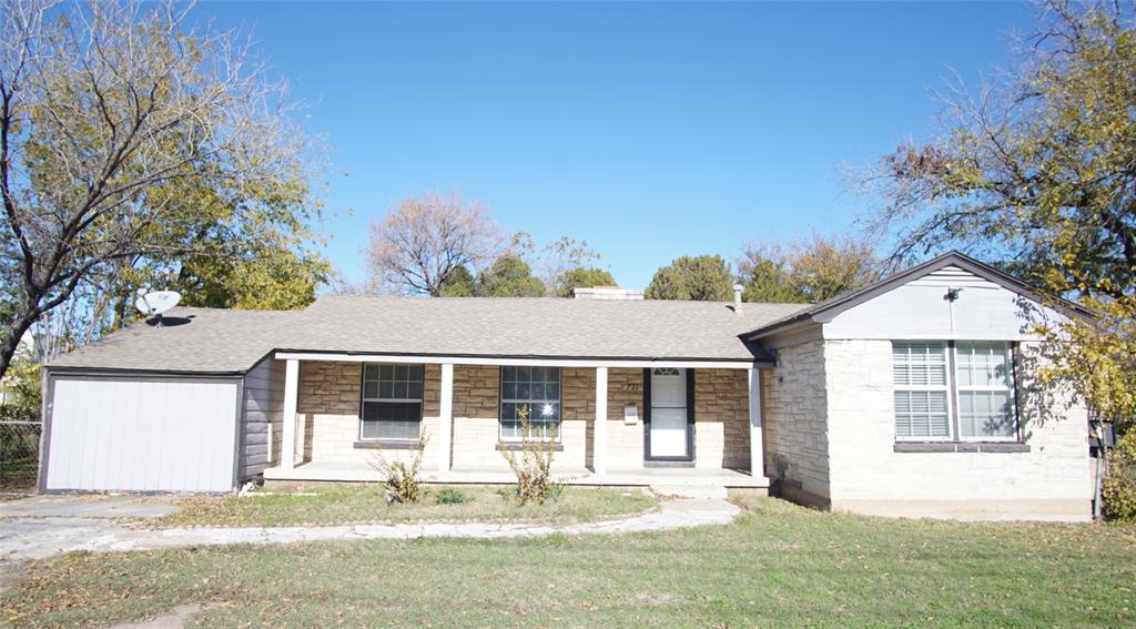 a front view of a house with a yard and porch