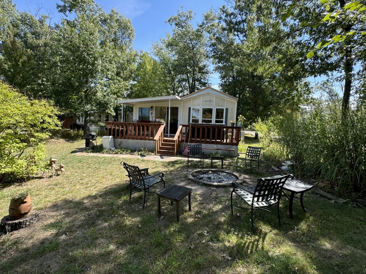 a view of a house with backyard sitting area and garden