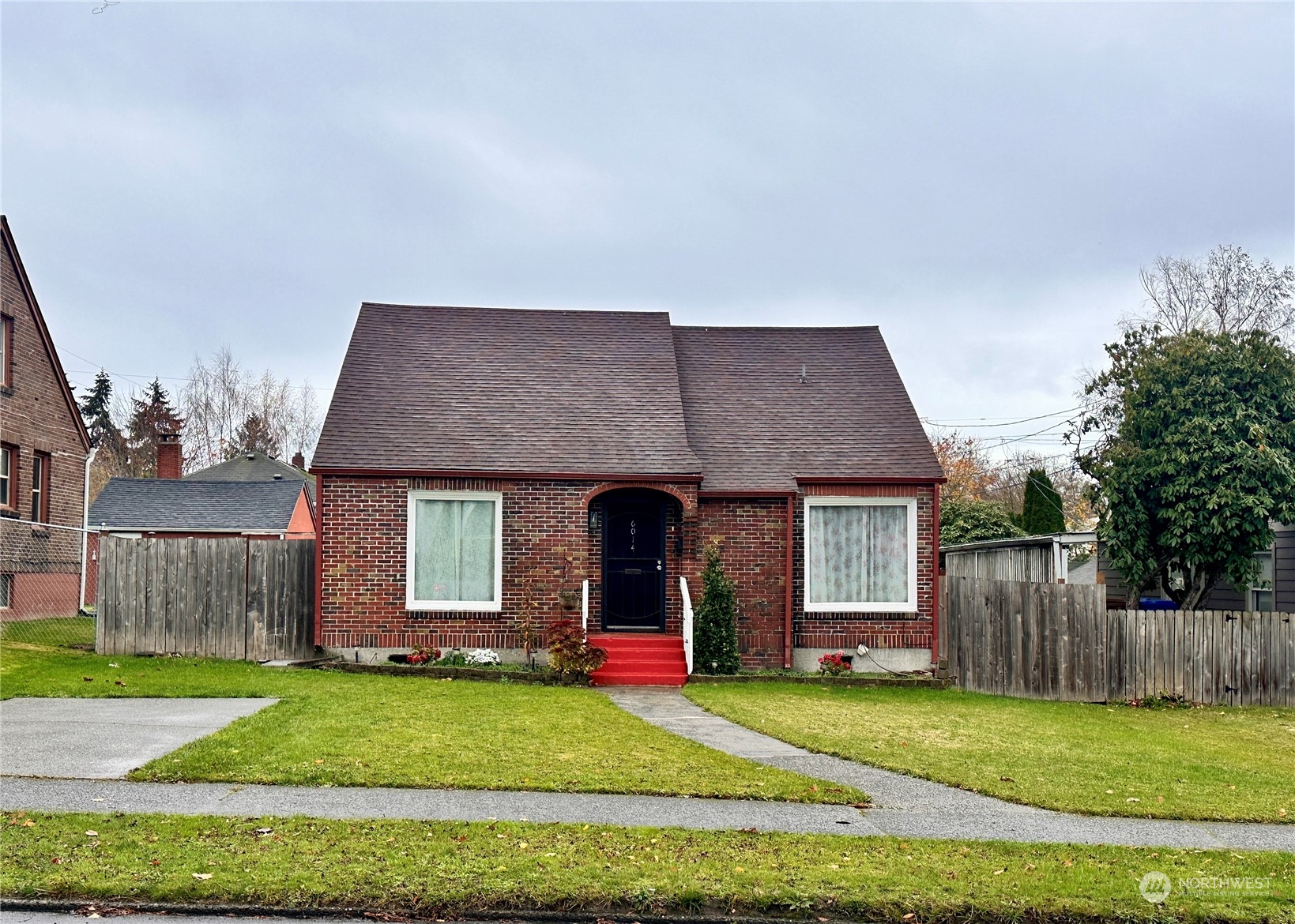 a view of a house with a yard and tree s