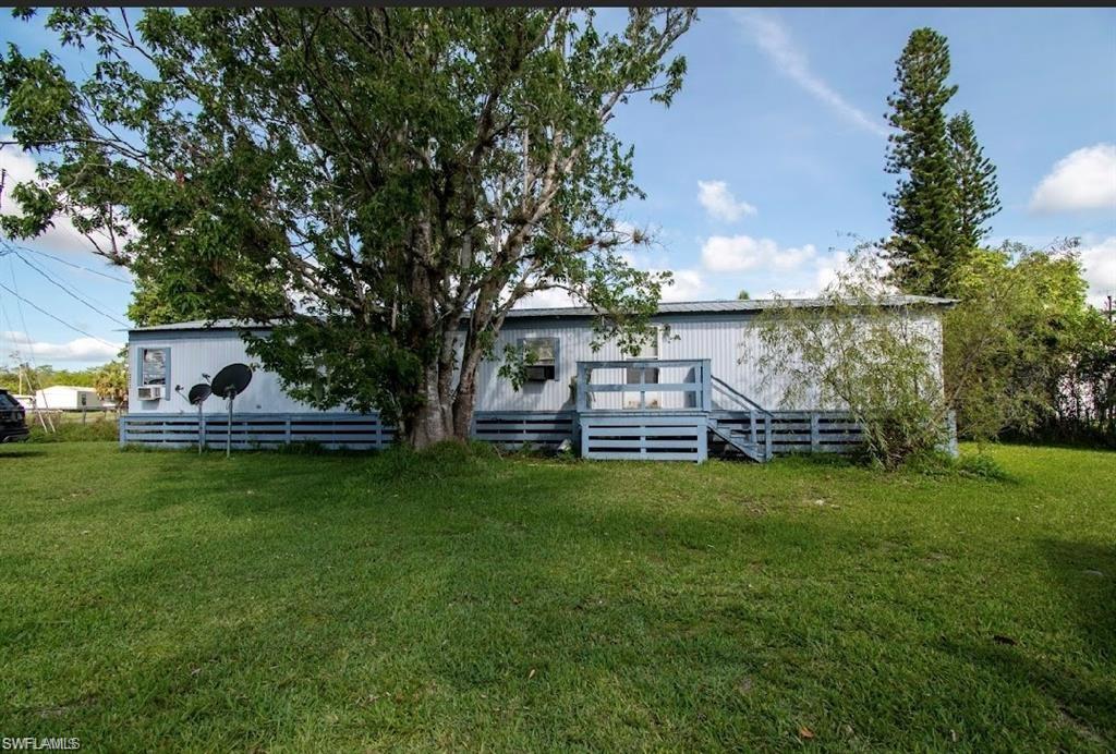 a front view of house with yard and green space