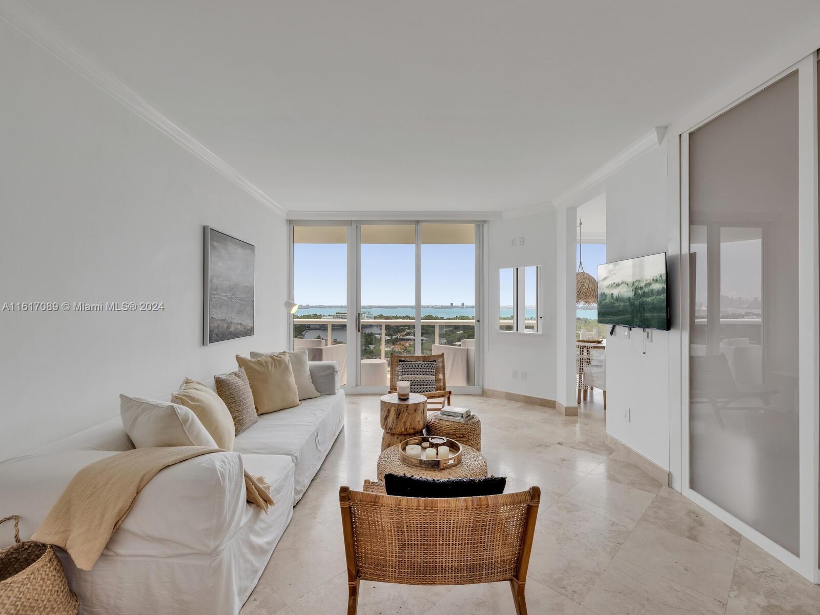 a living room with furniture and a floor to ceiling window