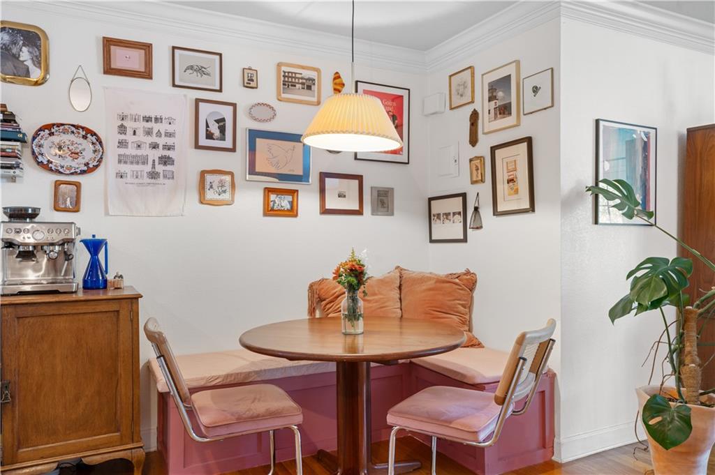 a dining room with furniture and wooden floor