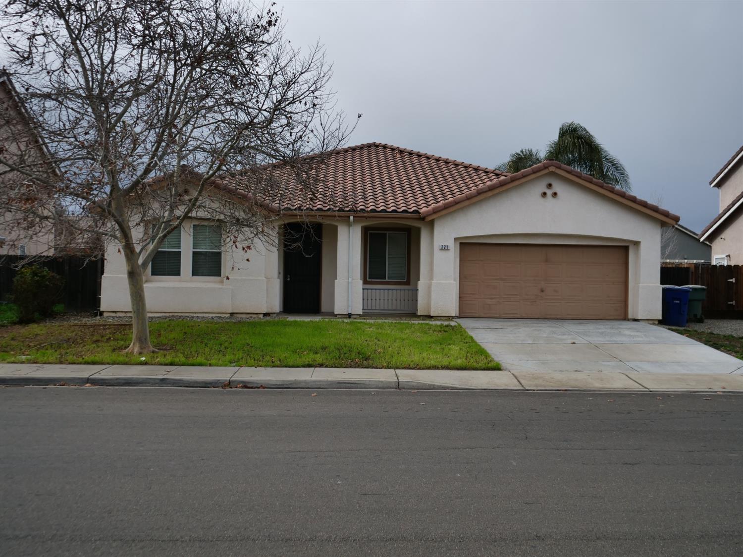 a front view of a house with a yard and a garage