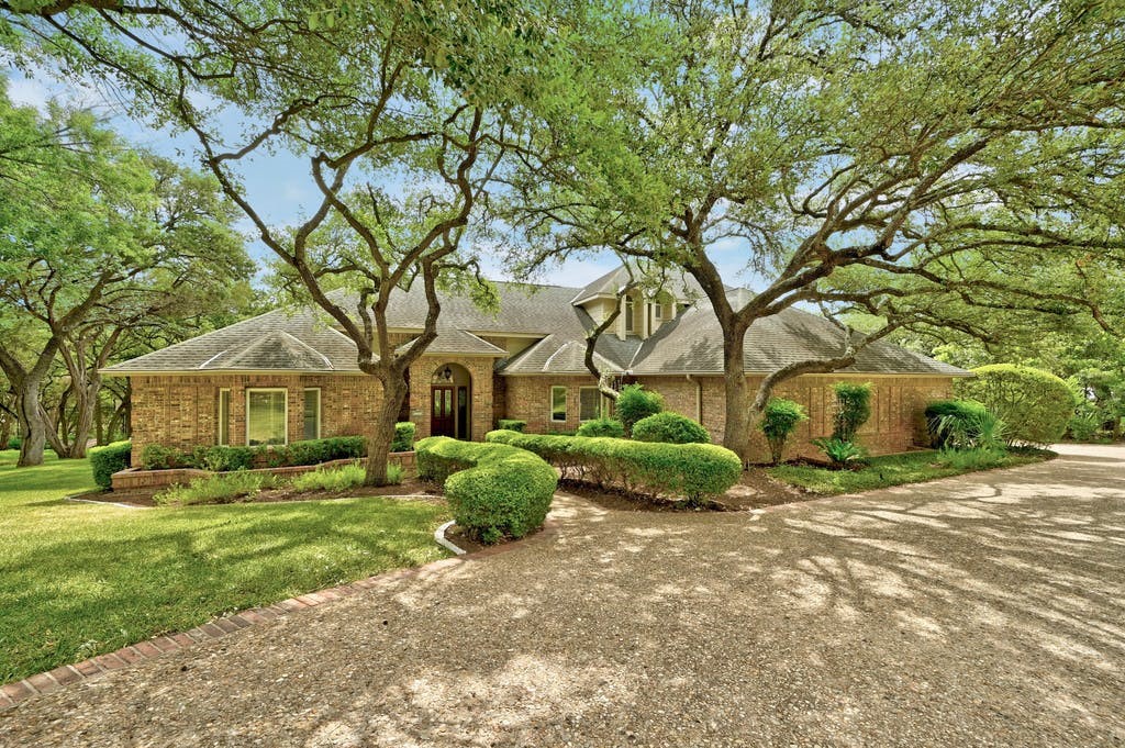 a front view of a house with garden