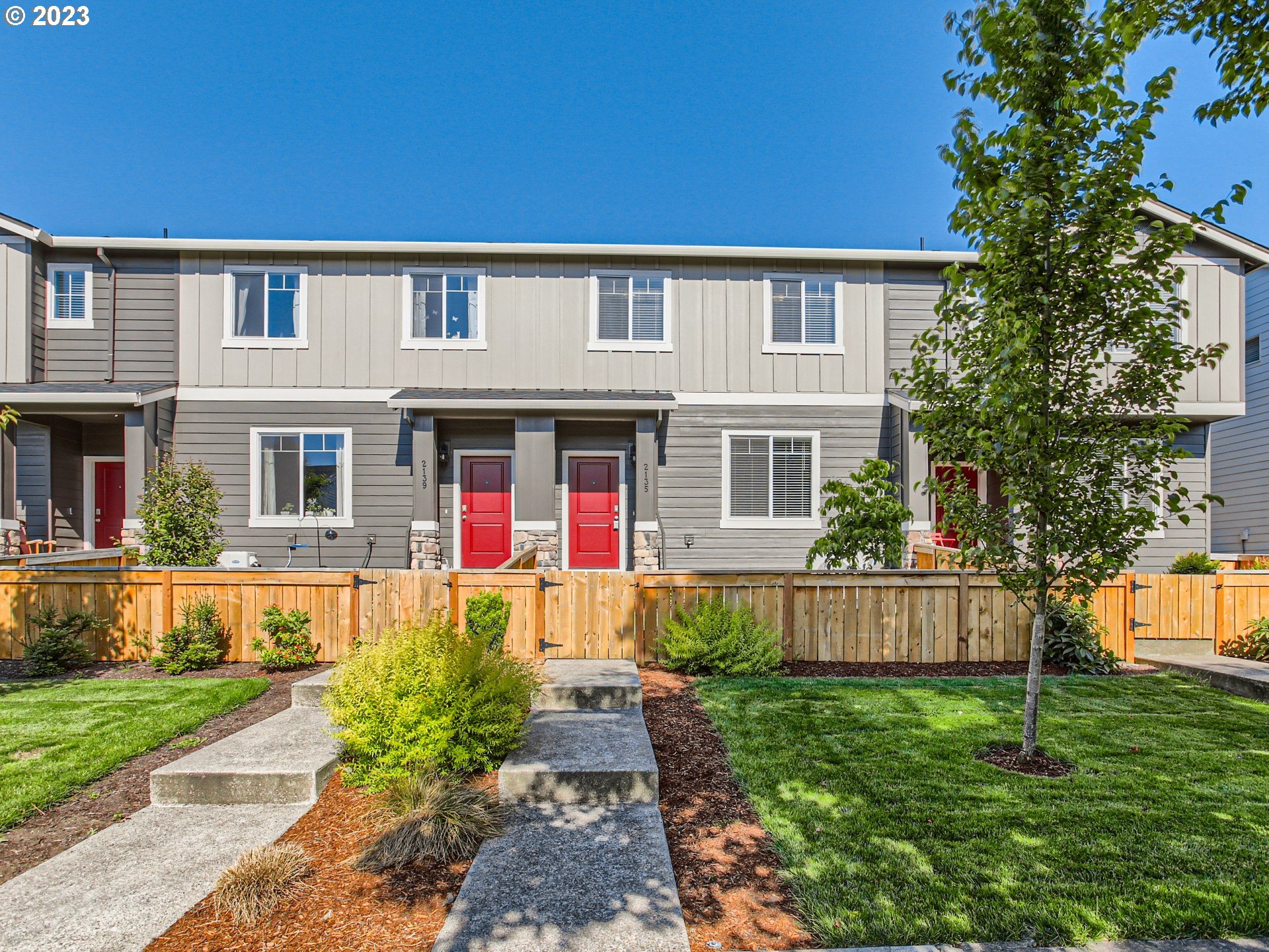 a front view of house with yard and green space