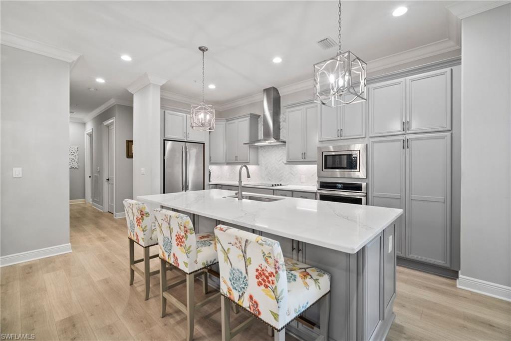 a large kitchen with a table and chairs