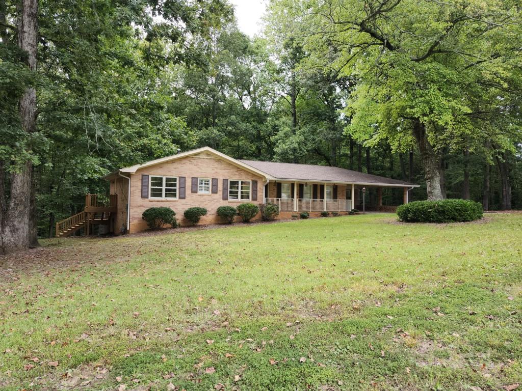 a front view of a house with a yard and trees