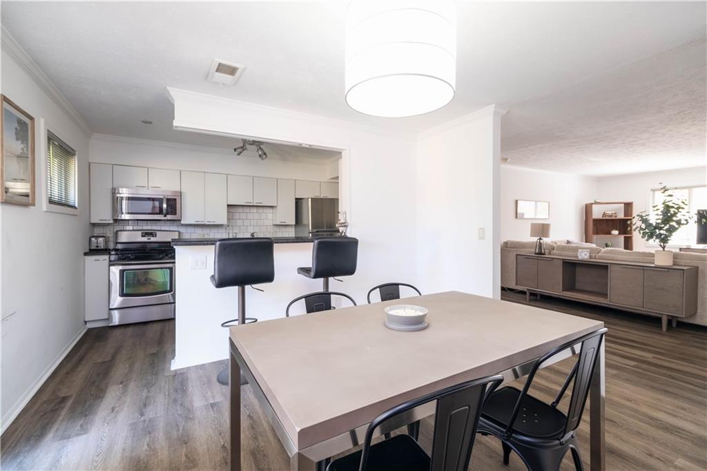 a view of kitchen with cabinets table and chairs