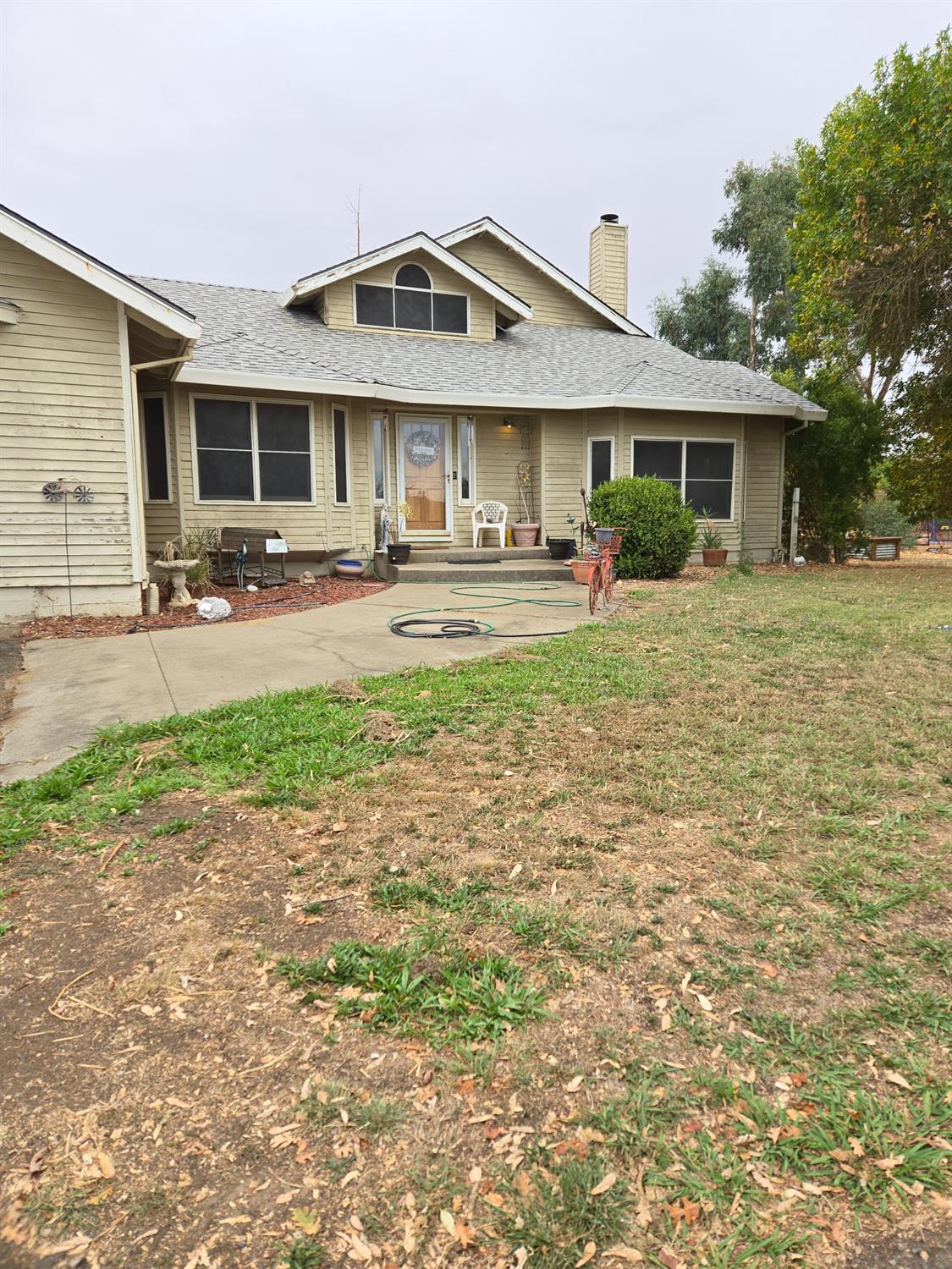 a front view of a house with yard patio and green space