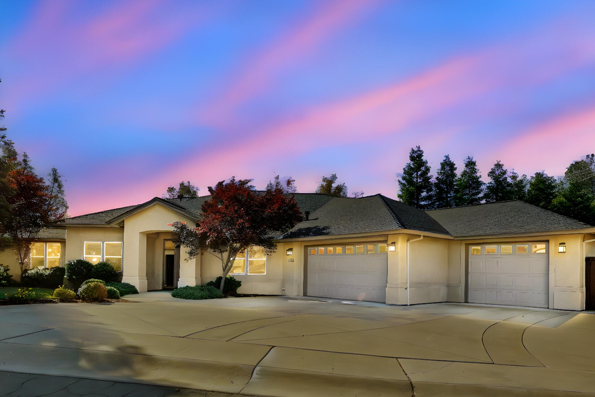 a view of a house with a yard and a garage