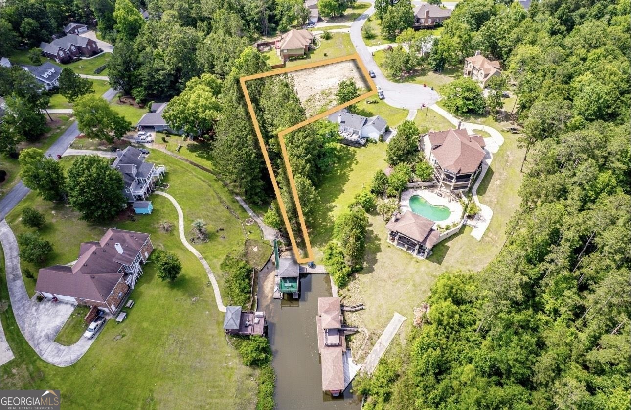 an aerial view of residential house with outdoor space and swimming pool