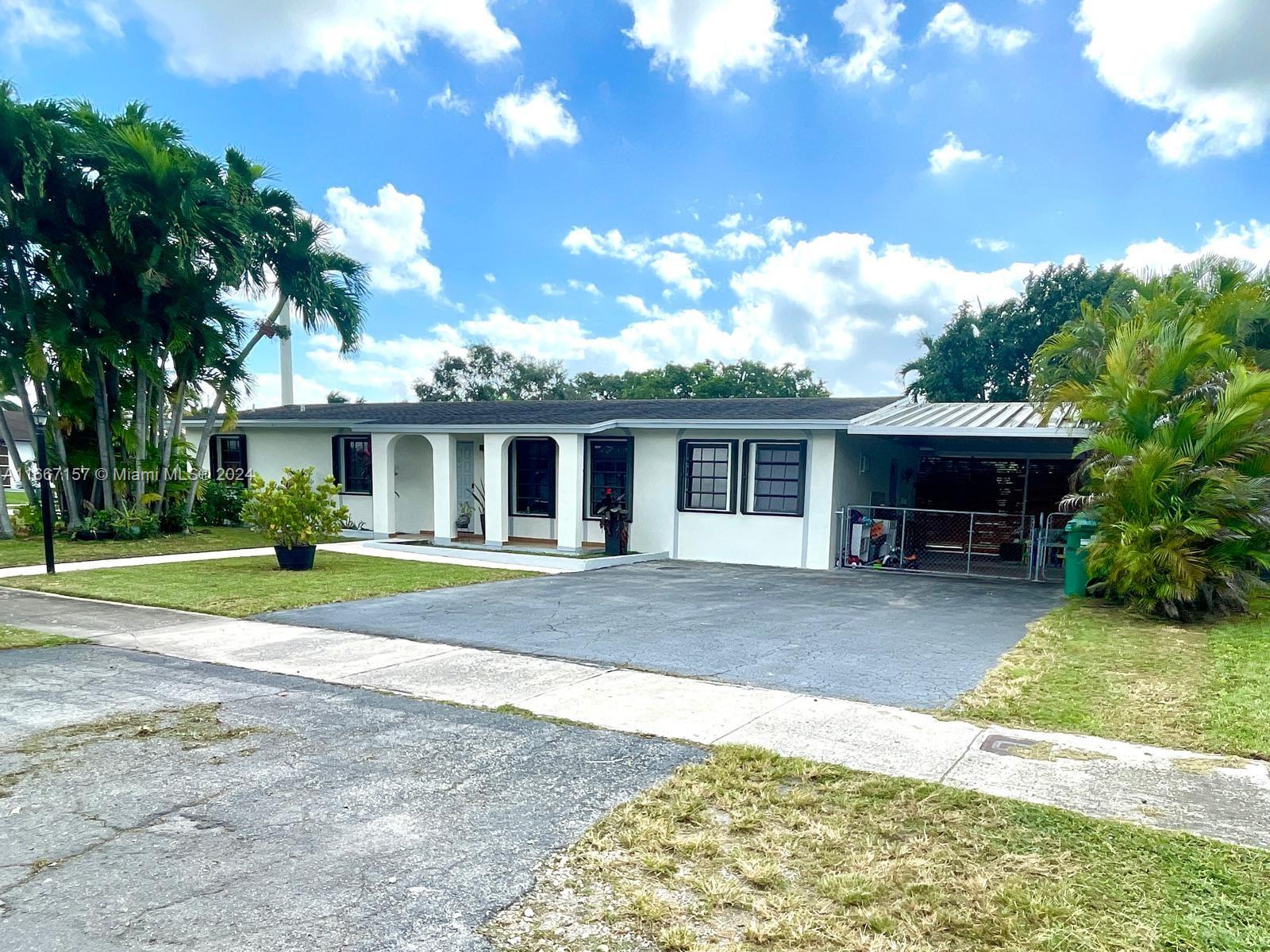 a front view of a house with a yard and porch