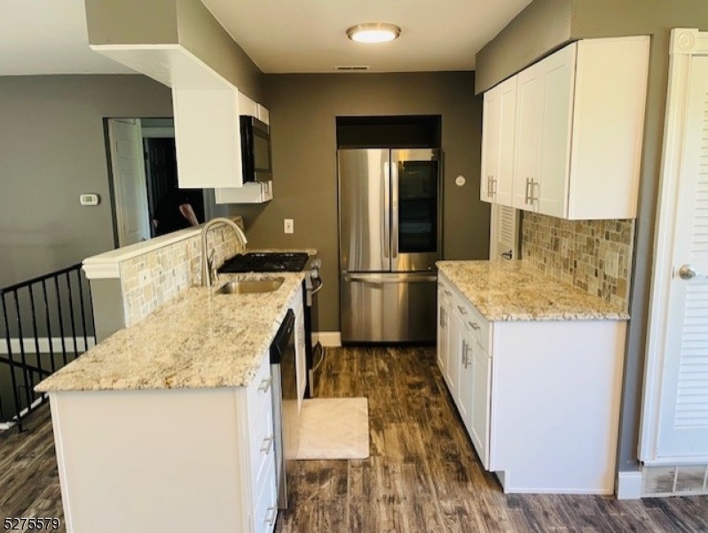 a kitchen with a sink stove and refrigerator