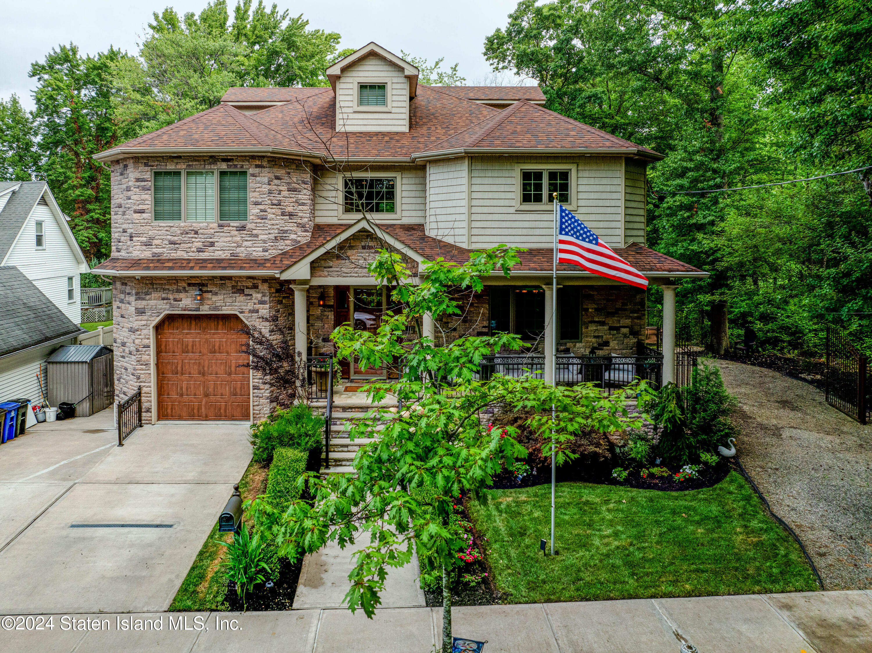 a front view of a house with a garden