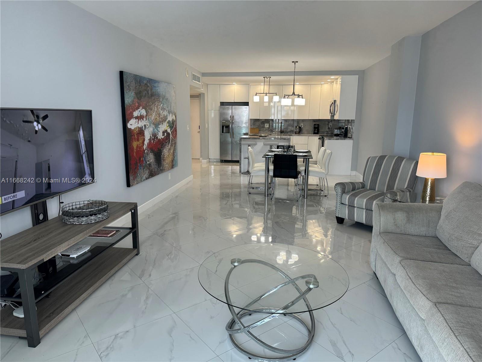 a living room with fireplace furniture and a flat screen tv